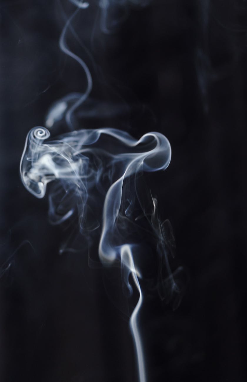 abstract background of wavy smoke in darkness